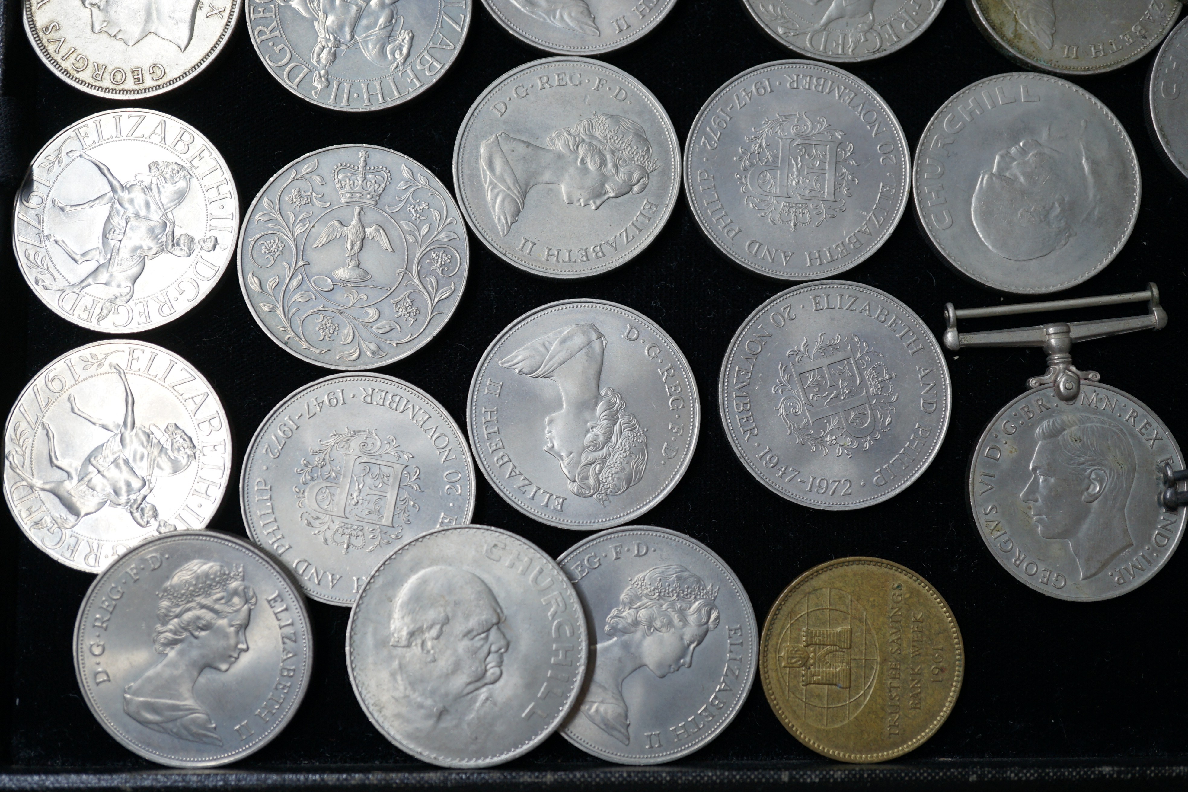 A group of QEII crowns and two medals